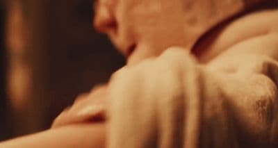 a close up of a person wearing a white shirt