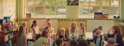 a group of children standing around each other in a room