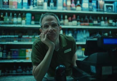 a man sitting at a cash register in a store