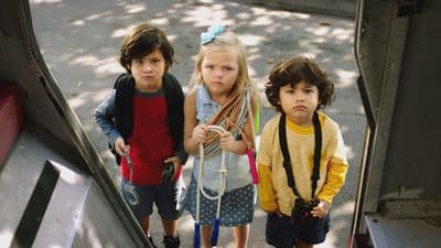 a group of three children standing next to each other