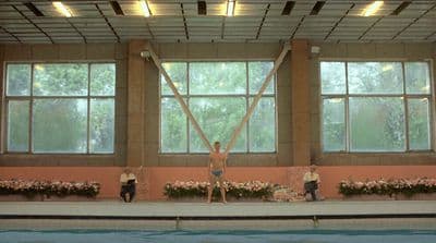 a group of people standing on top of a swimming pool