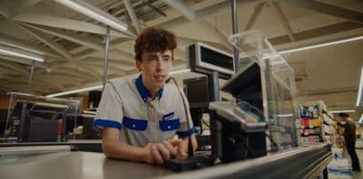 a man sitting at a cash register in a store