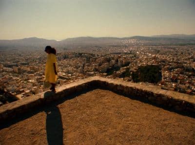 a woman standing on top of a stone wall