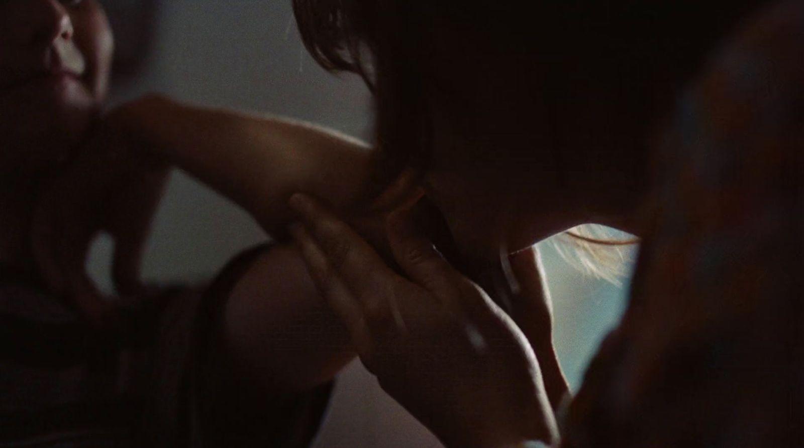 a woman is holding her hand up to her chest
