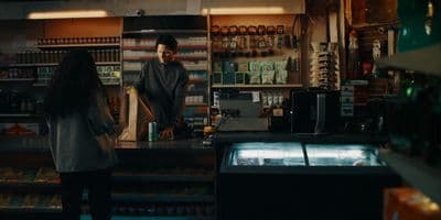 a woman standing at a counter in a store