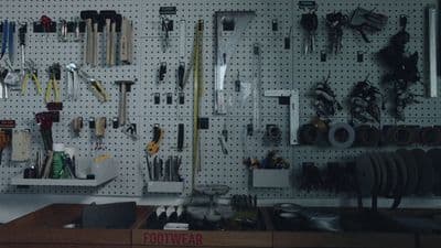 a pegboard with a bunch of tools hanging on it