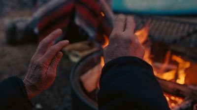 a person holding their hand over a fire