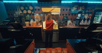 a woman standing in a fast food restaurant