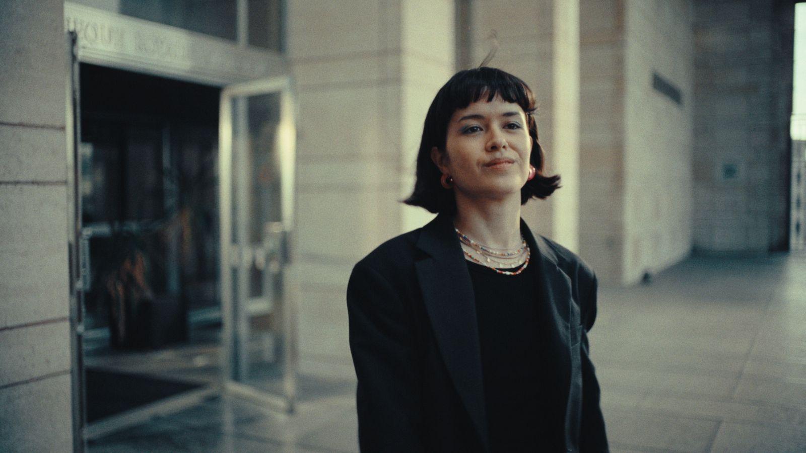 a woman standing in front of a building