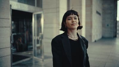 a woman standing in front of a building