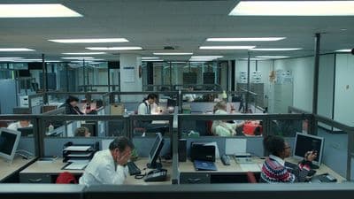 a group of people working in an office cubicle