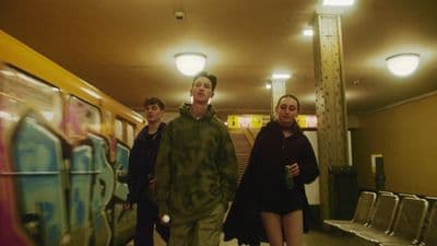 a group of people standing next to a train