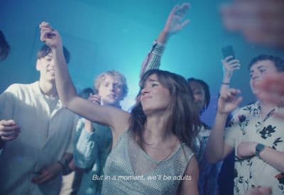 a woman standing in front of a crowd of people
