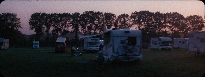a group of campers are parked in a field
