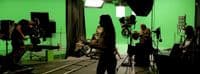 a group of people in a green screen studio