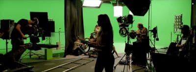 a group of people in a green screen studio