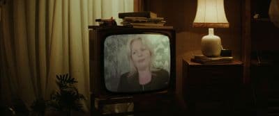a television sitting in a living room next to a lamp