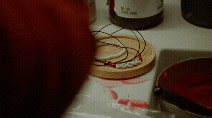 a person standing in front of a counter with a red substance on it