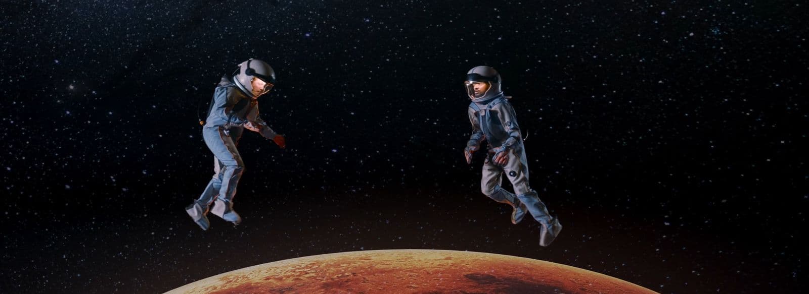 a couple of people in space suits flying over a planet