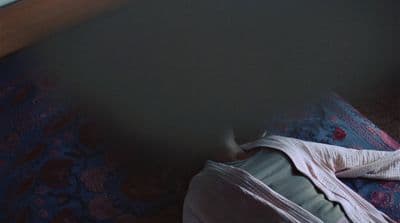 a person laying on a bed in a room