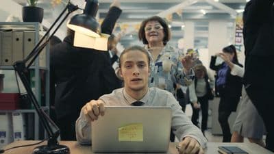a man sitting in front of a laptop computer