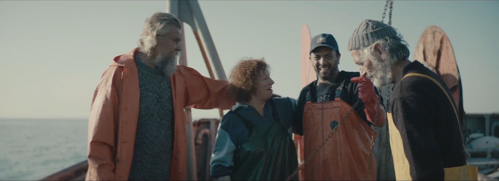 a group of people standing on top of a boat