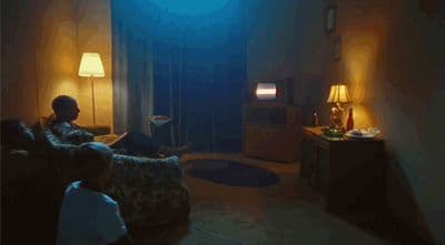 a man sitting on a couch in a living room