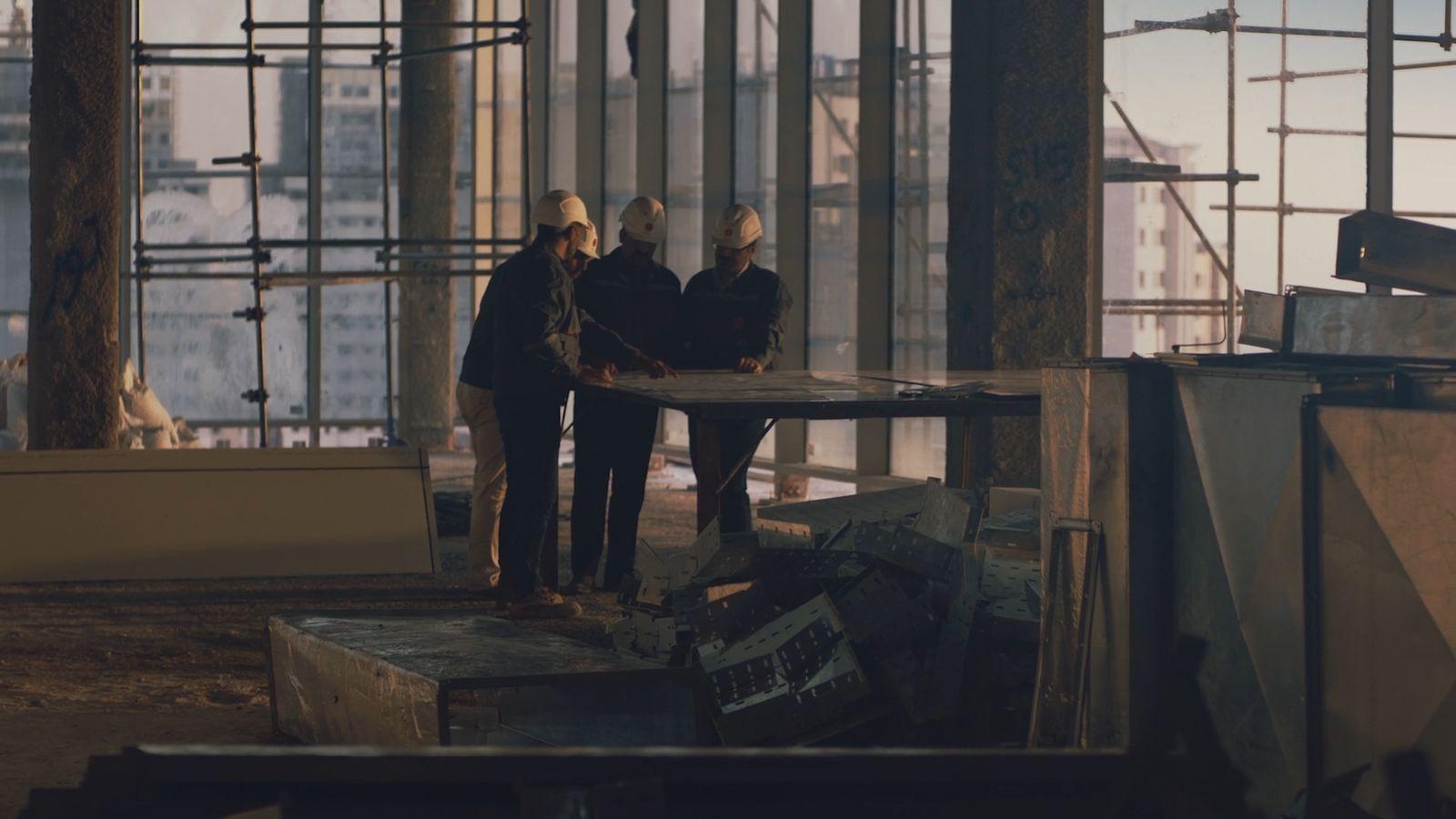 a group of people standing next to each other in a building