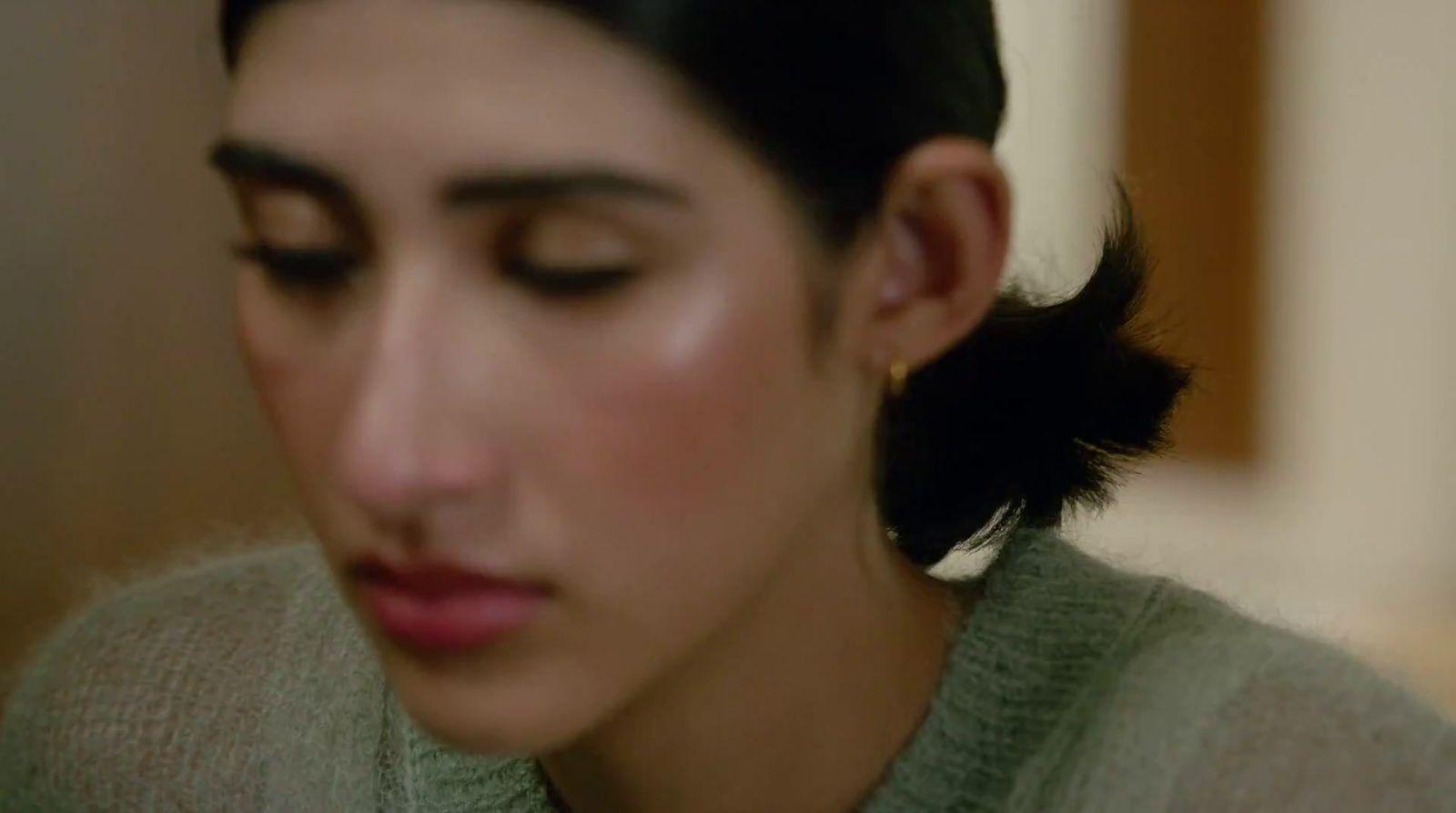 a close up of a person wearing a sweater