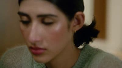 a close up of a person wearing a sweater