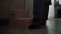 a person standing next to a step stool
