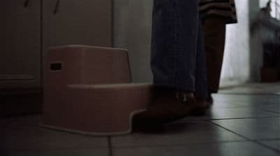 a person standing next to a step stool