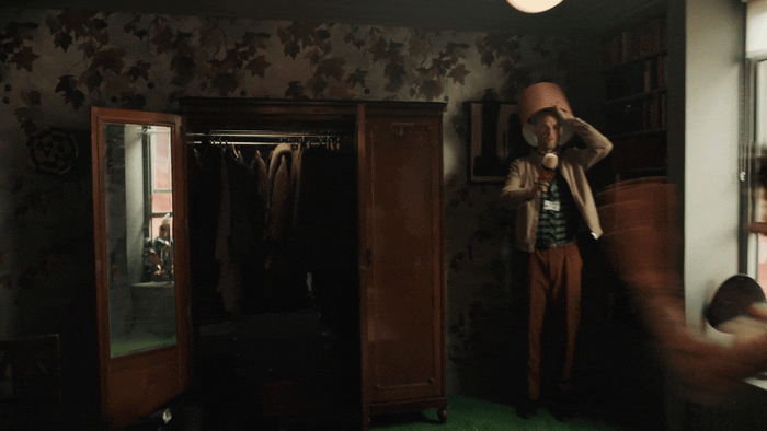a person standing in a room with a mirror