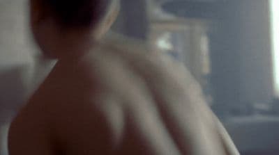 a blurry image of a man with no shirt on