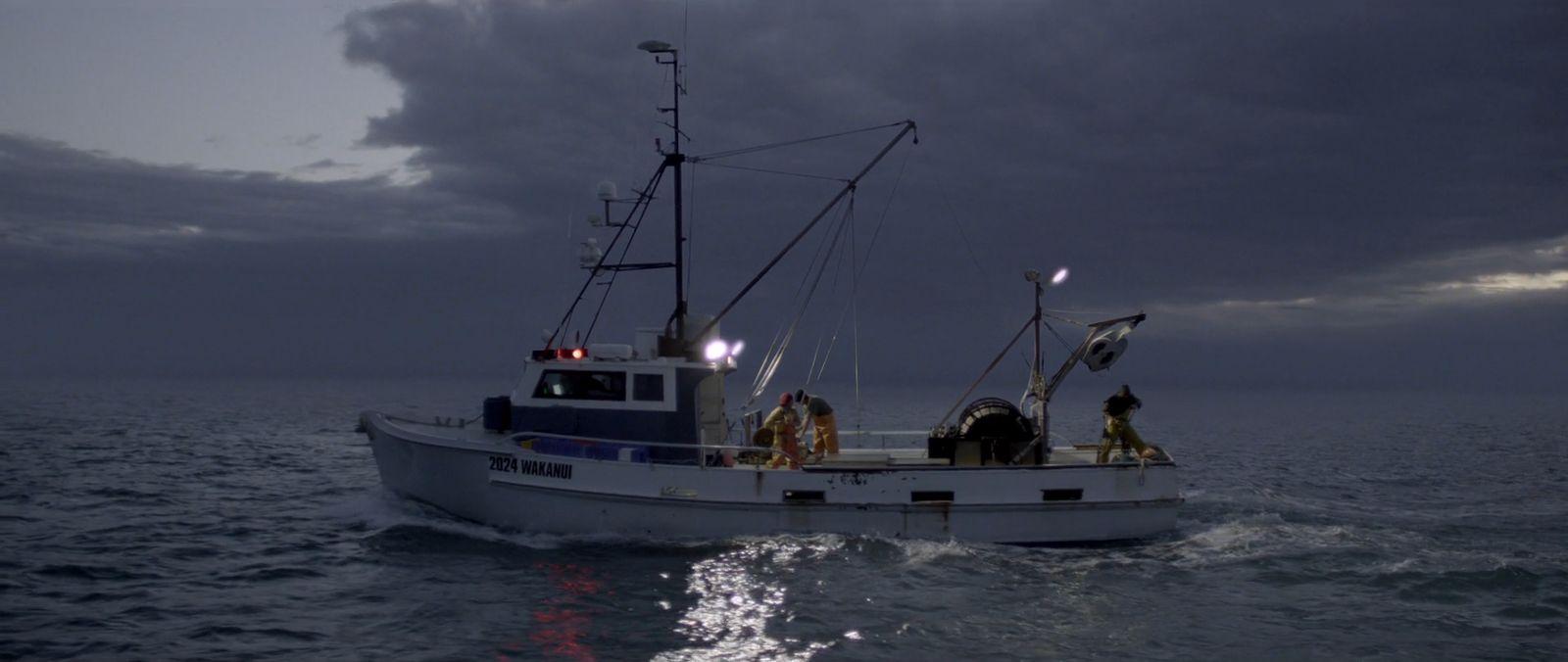 a fishing boat in the middle of the ocean