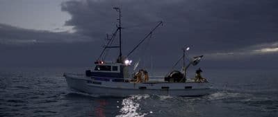 a fishing boat in the middle of the ocean