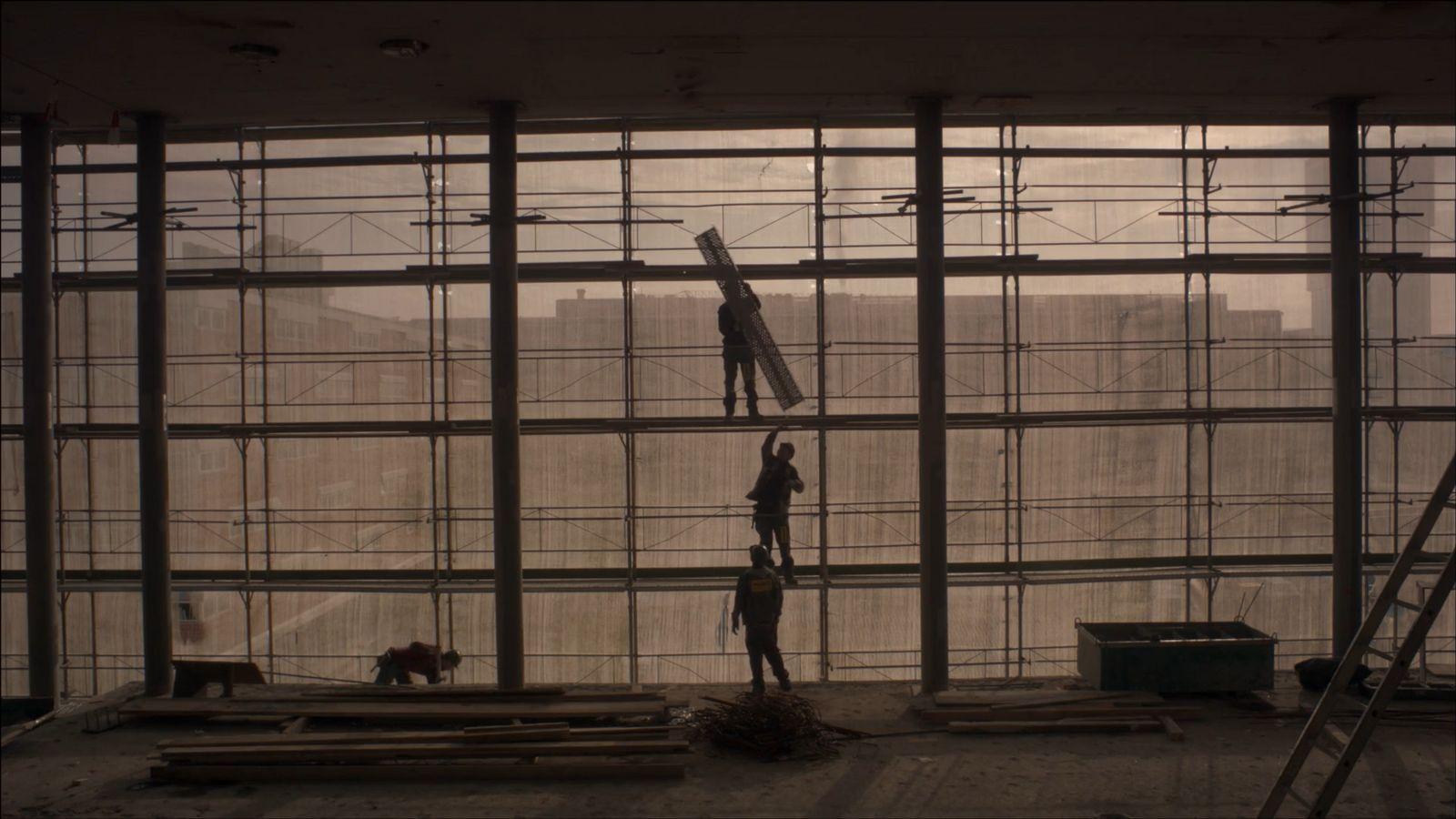 a person standing on a ladder in a building