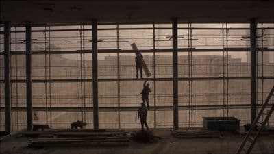 a person standing on a ladder in a building