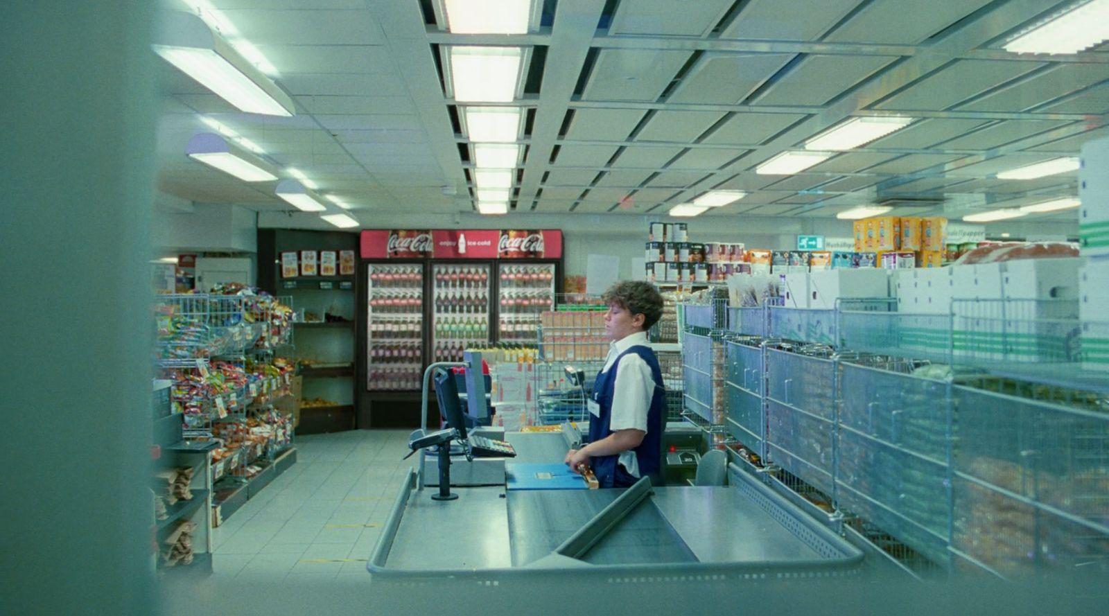 a man standing at a cash register in a store