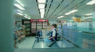 a man standing at a cash register in a store