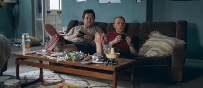 a couple of men sitting on top of a couch