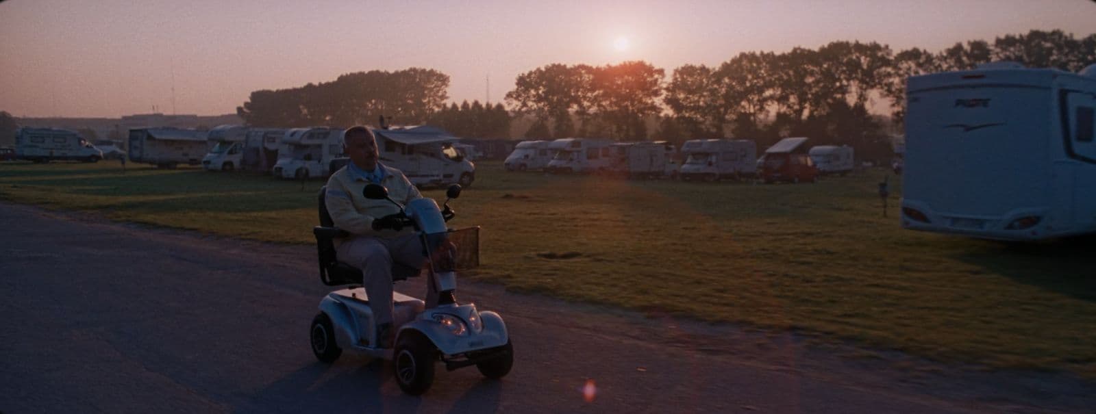 a man riding a motorized scooter down a road