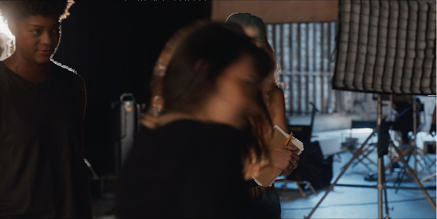 a man standing next to a woman in a recording studio