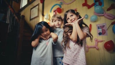a group of young girls standing next to each other