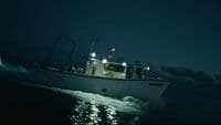 a white boat in the ocean at night