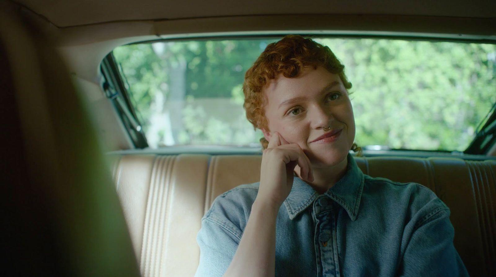 a woman sitting in the back seat of a car