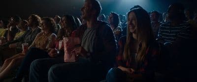 a group of people sitting in a dark room