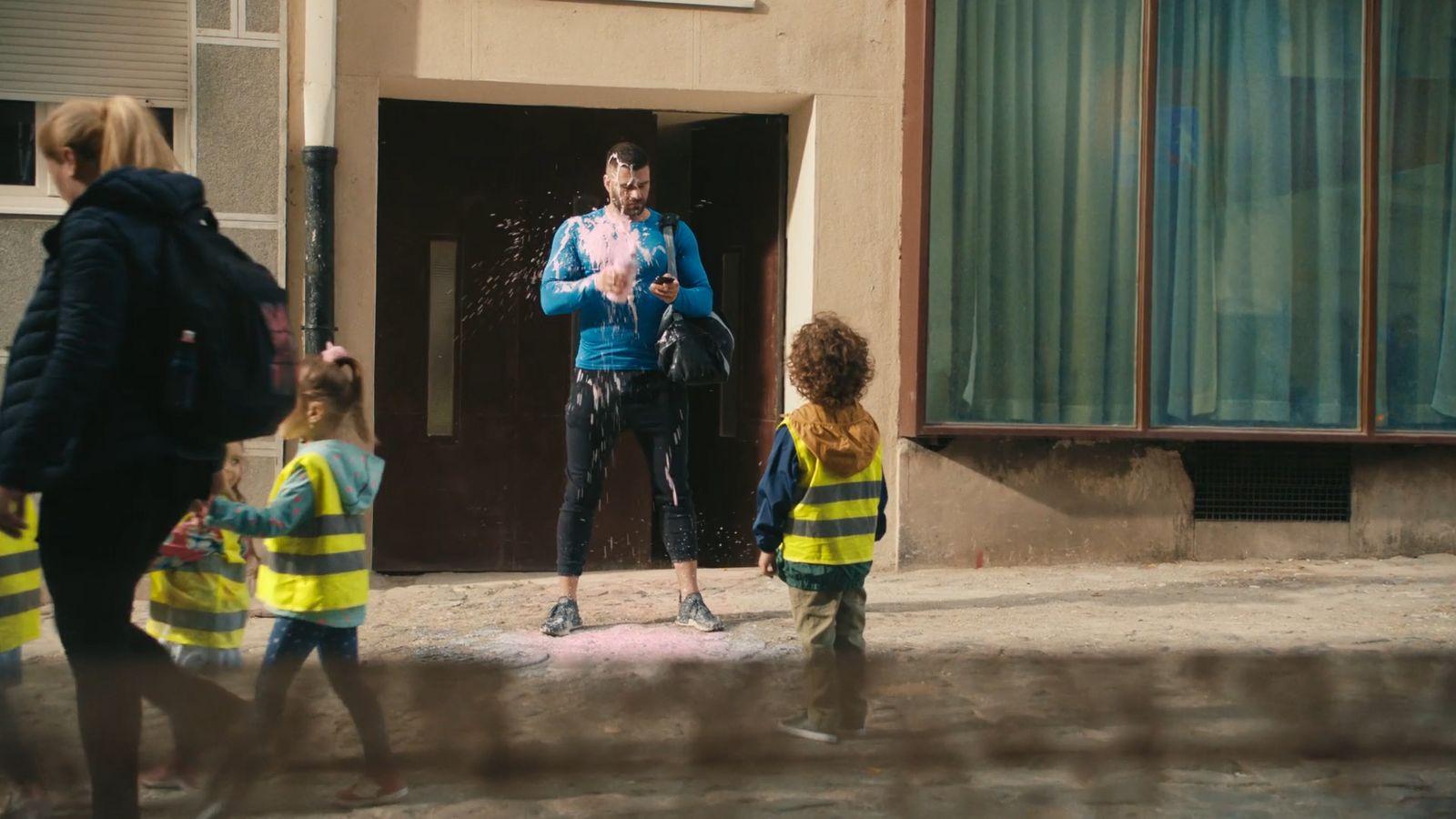 a man standing on top of a street next to a group of kids