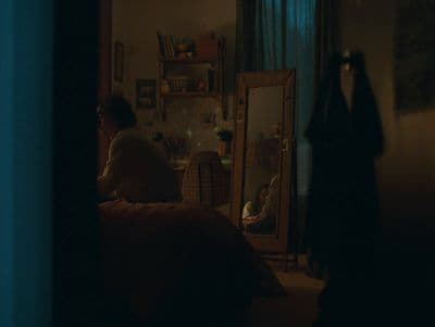 a person sitting in a room with a mirror