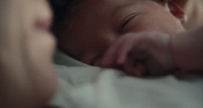 a close up of a person holding a baby